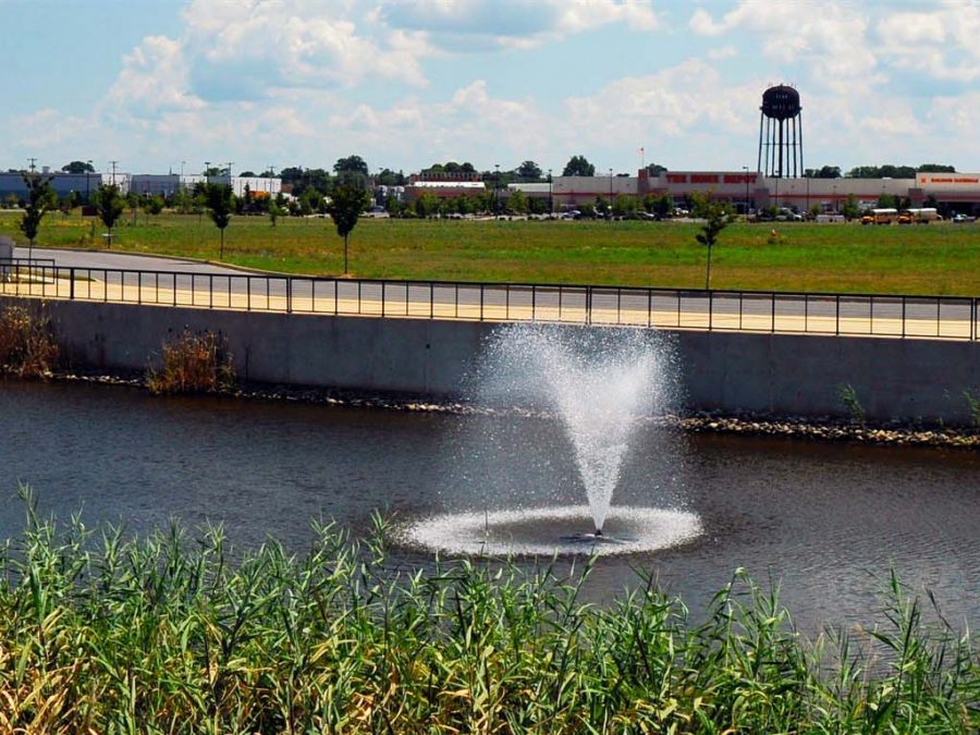 water fountains in man made lake near water tower