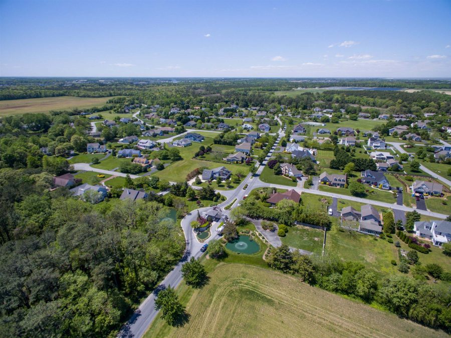 aerial of housing area with trees and grass